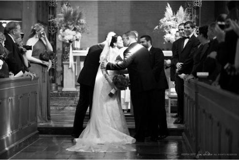 giving the bride away in pool of light black and white image