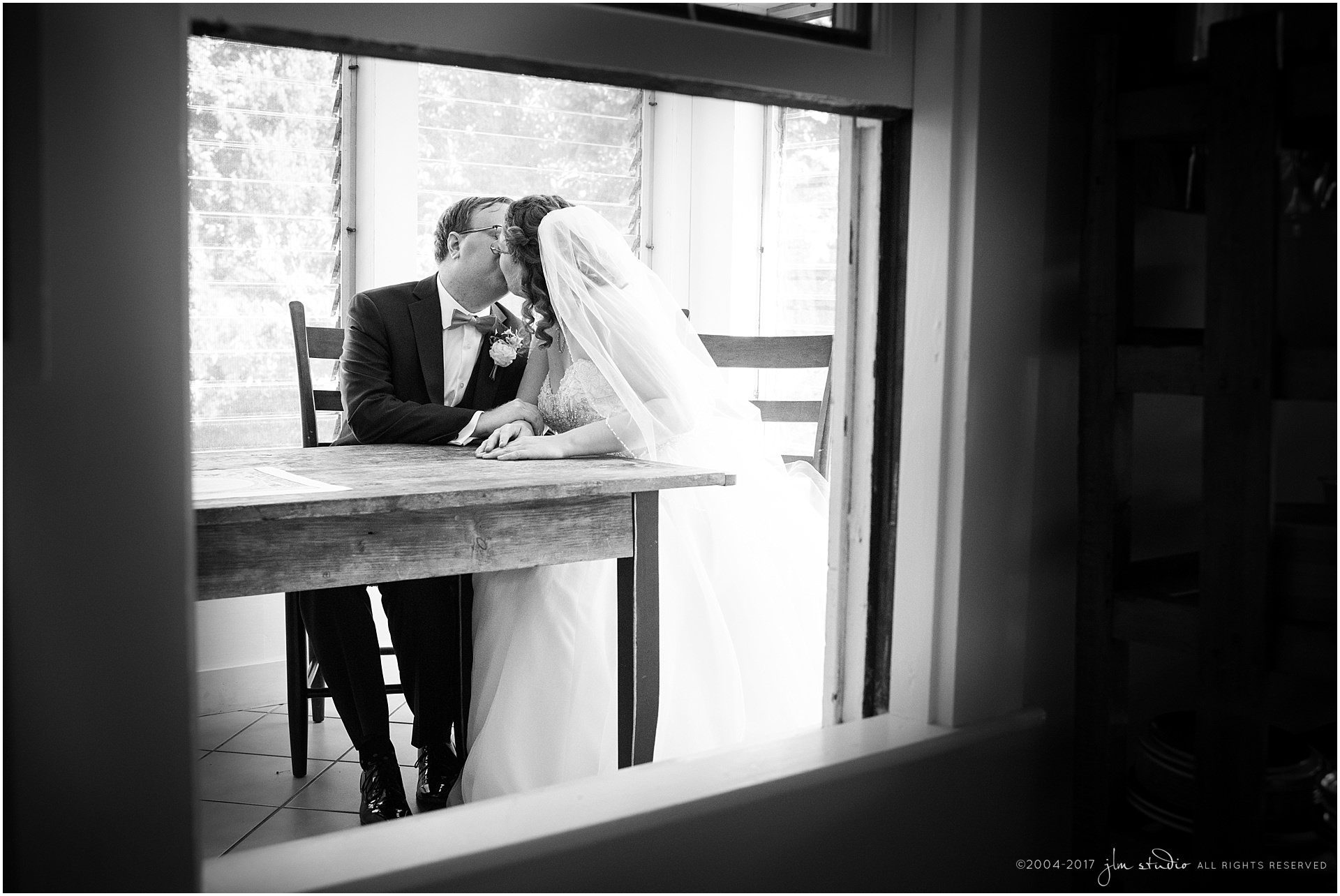 bride groom kissing black and white wedding image