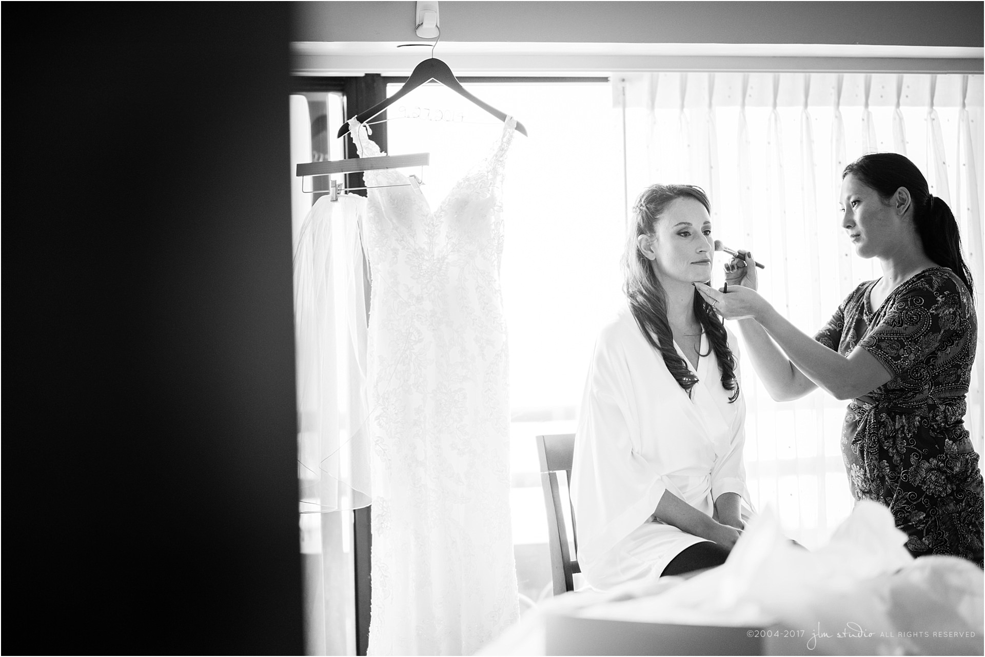 bride getting ready with wedding dress