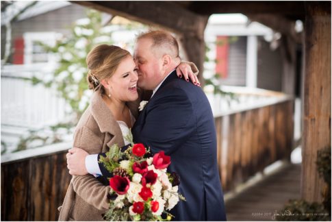 red lion inn winter wedding bride and groom red flowers