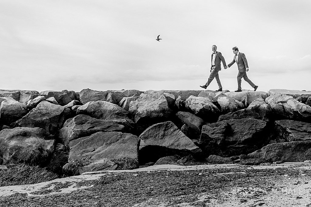 Two grooms walking on provincetown causeway