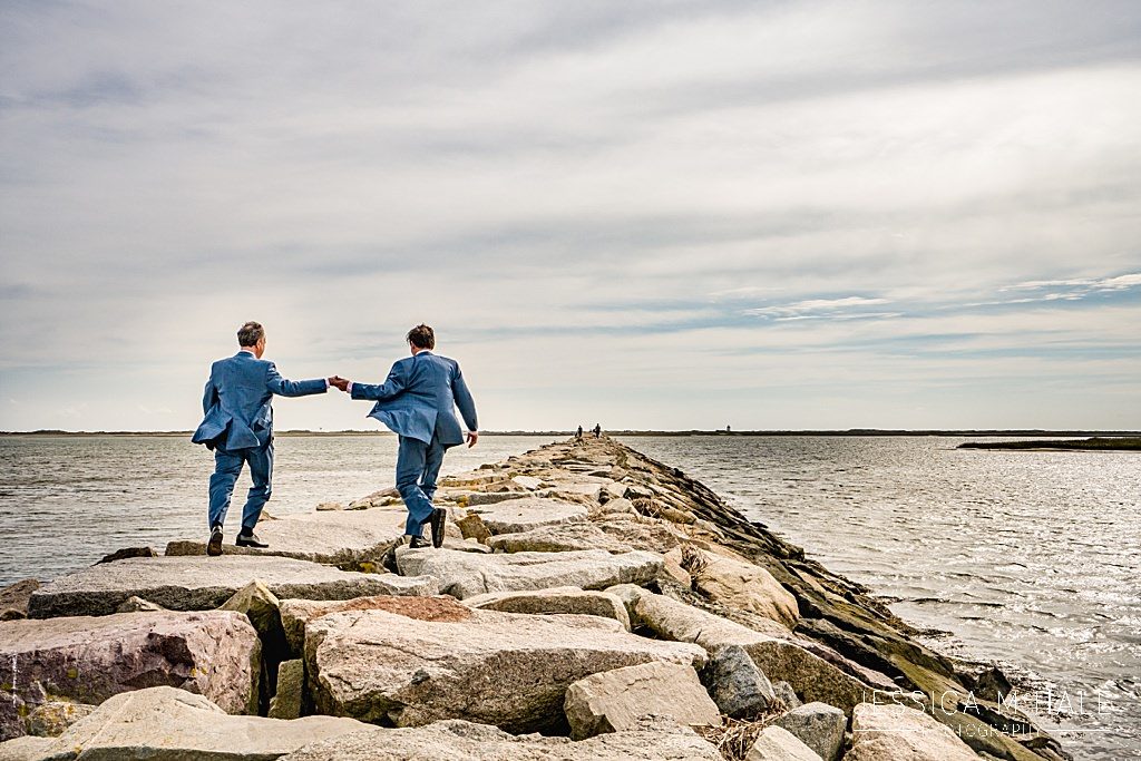 Two grooms walking on provincetown causeway